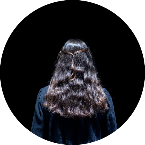 A woman, seen from behind, is looking at one of the works in the Quantum Revolution exhibition
